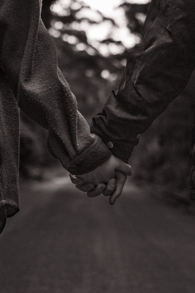 A black and white close-up of two hands holding photographed by Olivia Holley Studio
