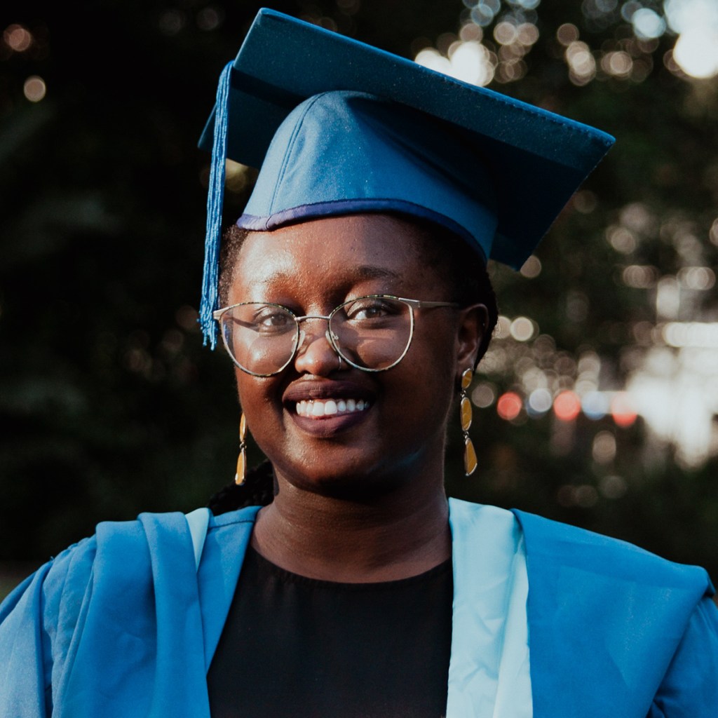 female graduate smiling photographed by Olivia Holley Studio