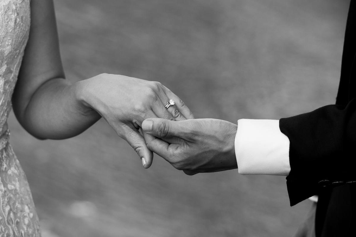 Groom holding his brides hand with the sparkling ring on display photographed by Olivia Holley Studio